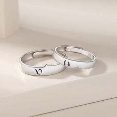 A gorgeous Kissing Couple Anniversary Rings Set for two is an open ended/adjustable size rings set, its inner round edges make it suitable for everyday wear. Personalized the rings set with names or any text of your choice in local languages and unique symbols which make the rings a unique promise/commitment or wedding anniversary gift for men and women. Material: White Gold Plated 925 Sterling Silver Adjustable Silver Initial Ring For Promise, Adjustable Engraved Ring With Initials, Personalized Sterling Silver Open Couple Rings, Personalized Sterling Silver Couple Rings With Open Design, Adjustable Engraved Couple Open Rings, Engraved Adjustable Open Couple Rings, Adjustable Open Band Couple Rings For Anniversary, Adjustable Symbolic Midi Rings For Wedding, Engraved Open Couple Rings For Promise