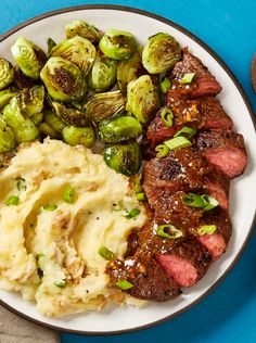 steak, mashed potatoes and brussel sprouts on a plate