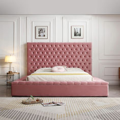 a pink bed with tufted headboard and foot board in a white walled room