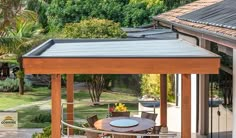 an outdoor dining area with table and chairs