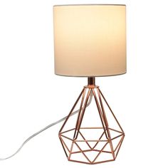 a table lamp with a white shade on the top and a wire frame around it