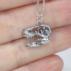 This sterling silver 3D T-Rex skull charm works great as a necklace or on a charm bracelet. 18mm long including jump ring 8mm wide We recommend a 1mm chain which is sold separately here. Product highlights: Made from 925 sterling silver. Comes in a black cotton filled jewelry box making it easy for gifting. Long Lasting & Worry Free. This item is solid sterling silver and is not plated or filled. Wear it in the shower, at the beach or wherever you go. Silver Novelty Necklaces With Charms, Novelty Silver Necklaces With Charms, Silver Novelty Jewelry With Lobster Clasp, Novelty Silver Pendant Jewelry, Nickel-free Sterling Silver Skull Jewelry, Engraved Sterling Silver Skull Jewelry, Skull Shaped Jewelry With Lobster Clasp For Gift, Novelty Sterling Silver Charm Jewelry, Novelty Sterling Silver Jewelry With Charms