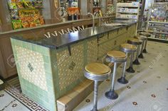 a row of stools sitting in front of a bar