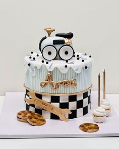 a cake decorated with an image of a train on top and cookies next to it