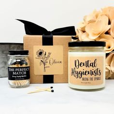 a candle and some matches are sitting next to a box with the words dental hygienists on it