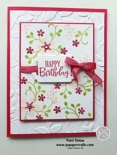 a happy birthday card with red ribbon and flowers on the front, in white background