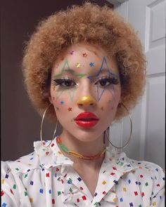 a woman with bright makeup and stars painted on her face