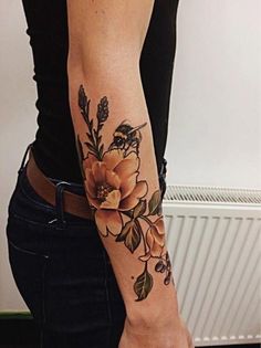 a woman with a flower tattoo on her arm