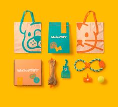 an assortment of items are laid out on a yellow background, including a tote bag