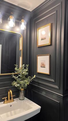 a white sink sitting under a bathroom mirror next to a wall mounted faucet