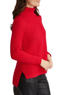 Get all cozy for the day in this chunky shaker-stitch turtleneck sweater knit with roomy raglan sleeves and a sporty high-low hem. 24" front length; 26 1/2" back length Turtleneck Long sleeves Side slits 100% cotton Machine wash, tumble dry Imported