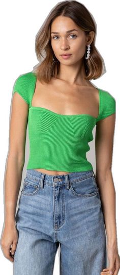 a woman in jeans and a green crop top