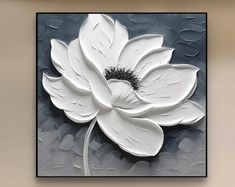 a large white flower on a gray background