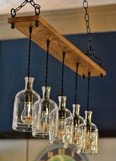 several bottles are hanging from a wooden shelf