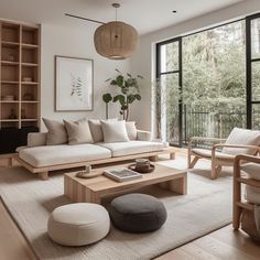 a living room filled with furniture and large windows