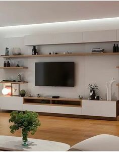 a living room filled with furniture and a flat screen tv on top of a wall