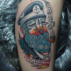 a sailor tattoo on the leg of a man