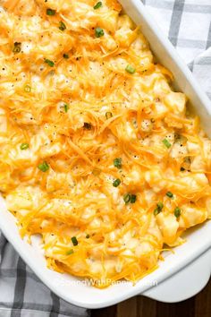 a casserole dish with cheese and green onions