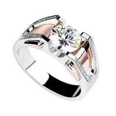 two tone gold and silver ring with cubics on the sides, set against a white background