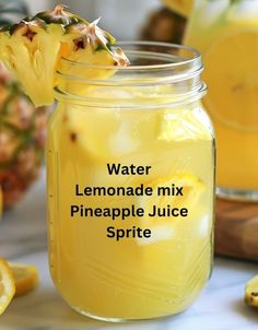 a glass jar filled with lemonade and pineapple juice