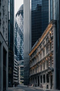 an empty city street with tall buildings and skyscrapers in the backgroung