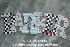 the word baby spelled with cars and checkered paper