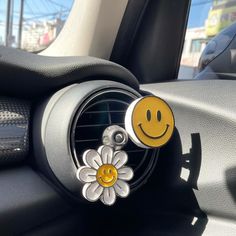 a car dashboard air vent with a smiley face on it