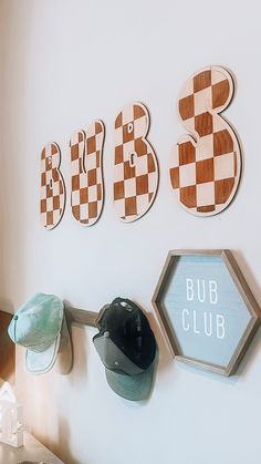 the wall is decorated with wooden signs and hats