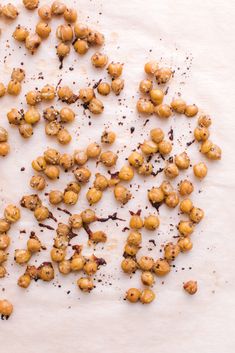 roasted chickpeas are scattered on a white surface