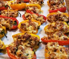 stuffed bell peppers with meat and cheese on them are ready to be cooked in the oven