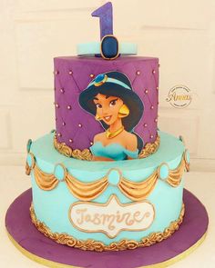 a birthday cake with the number one on it's top and princess ariel from disney