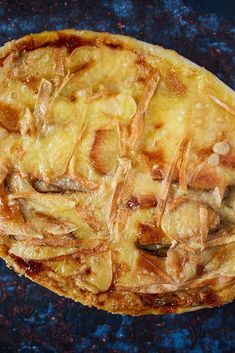 an apple pie sitting on top of a blue counter