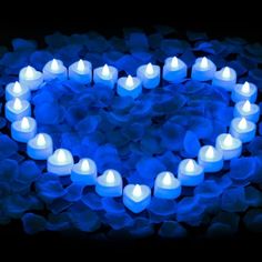 blue heart shaped candles lit up in the dark