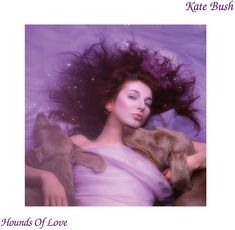 a woman laying on top of a bed next to a dog and her hair blowing in the wind