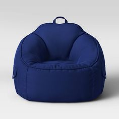 Provide your kiddo a comfy spot to perch with the Canvas Bean Bag Chair from Pillowfort™. Draped in a soft fabric and filled full with soft beads, this kids bean bag chair offers them complete sitting comfort. Featuring a solid hue with piped detailing for a finished look, it brings a pop of their favorite color to their room, while two side flap pockets provide them a safe spot to stash candy, card games, books and other knickknacks. Plus, it's designed with a fabric tote handle at the top that Fuzzy Bean Bag Chair, Activity Chair, Glider And Ottoman, Toddler Chair, Kids Bean Bags, Bean Bag Chair Kids, Pillow Fort, Fabric Tote, Bag Chair