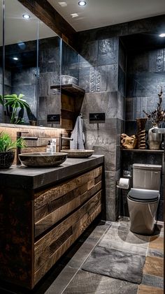 a bathroom with a toilet, sink and wooden cabinet in the center is decorated with plants