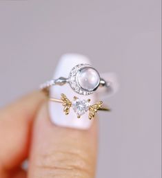 Sailor moon Vibes🌙✨ #ring #rings #gold #whitegold #moon #cresentmoon #angel #wings #heart #moonstone #diamond #diamondring #jewelry #stackingrings #heartring #moissanite #sailormoon Ethereal Gold Moonstone Ring For Gift, Ethereal Gold Moonstone Ring Gift, Moon Shaped Rose Cut Diamond Jewelry Gift, Dainty Gold Moonstone Ring In Sterling Silver, Ethereal Jewelry For Anniversary With Moon Phase, White Gold Moon Phase Ring For Promise, White Gold Moon Phase Promise Ring, Celestial Sterling Silver Moonstone Open Ring, Celestial Style Moonstone Promise Ring