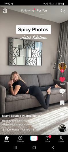 a woman laying on top of a couch in front of a wall with pictures and text