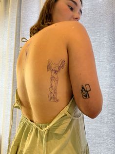 a woman with a tattoo on her back