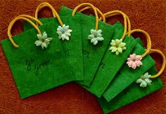 five small green bags with flowers on them