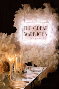 the great wadduck's sign is lit up with white feathers and candles