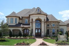 a large house with lots of windows and landscaping