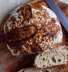 a loaf of bread sitting on top of a wooden cutting board