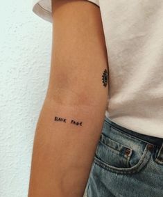 a person with a tattoo on their arm that says bank note in black ink,