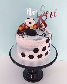 a soccer themed cake on a black and white plate