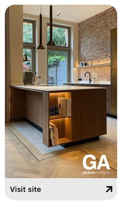 an open cabinet in the middle of a kitchen with a brick wall and window above it