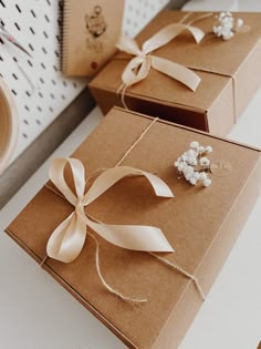 two brown boxes with white flowers tied to them