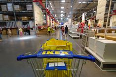 a shopping cart with the word ike's on it in a large store aisle