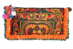 Our Two-tone Pom Poms Wristlet Clutch is handmade by Thai women Artisans. A boho-chic women's clutch, sustainably made that features an embroidered bird pattern.  Adorned with colorful handmade pom poms. * L 14 " x W 1" x H 7" * Made following Fair Trade guidelines * Handmade in Thailand Bohemian Clutch With Handwork As A Gift, Bohemian Clutch With Tassels, Bohemian Green Clutch As Gift, Handmade Bohemian Clutch With Multicolor Embroidery, Handmade Green Bohemian Clutch, Bohemian Clutch With Handwork, Traditional Handmade Clutch With Multicolor Embroidery, Traditional Multicolor Embroidered Clutch For Festival, Bohemian Multicolor Embroidery Clutch