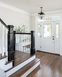 an entryway with stairs and railings leading to the front door